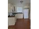 Functional kitchen featuring white appliances, countertops, cabinets, and tiled floors at 2411 5Th Avenue E Dr, Palmetto, FL 34221