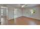 Neutral-toned room with tiled floor, white door, ceiling fan and natural light from a window with blinds at 2411 5Th Avenue E Dr, Palmetto, FL 34221