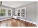 Well-lit bedroom with gleaming hardwood floors, complemented by a classic white dresser under bright windows at 2529 7Th W Ave, Bradenton, FL 34205