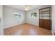 Bedroom with wood floor, natural light, and built-in shelving unit at 2606 Bismark Way, Sarasota, FL 34231