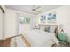 A cozy bedroom features light yellow paint, wood laminated floors and white furnishings at 2606 Bismark Way, Sarasota, FL 34231