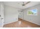 Simple bedroom with wood floor, closet with mirror door, and natural light from the window at 2606 Bismark Way, Sarasota, FL 34231
