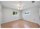 Bedroom featuring hardwood floors, two windows bringing in natural light, and ceiling fan at 2606 Bismark Way, Sarasota, FL 34231