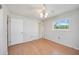 Bedroom featuring hardwood floors, one window bringing in natural light, and ceiling fan at 2606 Bismark Way, Sarasota, FL 34231