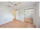 Bedroom with wood floor, closet with mirror door, and ceiling fan at 2606 Bismark Way, Sarasota, FL 34231