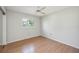 A bright bedroom featuring neutral paint, laminated wood floors, and a ceiling fan at 2606 Bismark Way, Sarasota, FL 34231