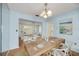 Staged dining room featuring wood floors with natural light at 2606 Bismark Way, Sarasota, FL 34231