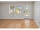 Bright living room featuring wood floors, a window overlooking the front yard and a decorative front door at 2606 Bismark Way, Sarasota, FL 34231