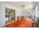 Sitting room with carpet and shelving unit that leads to an enclosed porch at 2606 Bismark Way, Sarasota, FL 34231