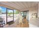 Enclosed patio with tile flooring, outdoor dining set, and access to the pool at 2606 Bismark Way, Sarasota, FL 34231
