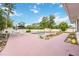 Backyard with a private in-ground pool surrounded by a pink concrete patio and landscaping at 2606 Bismark Way, Sarasota, FL 34231