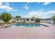 Backyard pool with a pink deck and well-maintained landscaping at 2606 Bismark Way, Sarasota, FL 34231