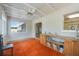 Bright sunroom featuring large windows, orange carpet, and built-in wooden shelving at 2606 Bismark Way, Sarasota, FL 34231