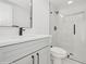 A modern bathroom features a glass-enclosed shower and a vanity with a sleek black faucet and hardware at 2655 Bay St, Sarasota, FL 34237