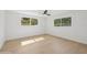 A bright, spacious bedroom with wood flooring and windows allowing natural light and views at 2655 Bay St, Sarasota, FL 34237