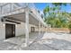 Covered patio with white support beams and pebble ground cover at 2655 Bay St, Sarasota, FL 34237