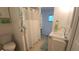 Well-maintained bathroom includes a shower with white curtain, vanity, sink, and built-in cabinet at 3333 26Th E Ave # 1132, Bradenton, FL 34208