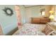 Charming bedroom with a floral bedspread and an adjacent doorway leading to the bathroom at 3333 26Th E Ave # 1132, Bradenton, FL 34208