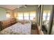 Comfortable bedroom with large windows, floral bedspread, and mirrored closet doors at 3333 26Th E Ave # 1132, Bradenton, FL 34208