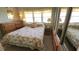 Cozy bedroom featuring a floral-patterned bedspread, ample natural light, and closet space at 3333 26Th E Ave # 1132, Bradenton, FL 34208