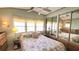 Bright bedroom with ample natural light, floral bedspread, and mirrored closet doors at 3333 26Th E Ave # 1132, Bradenton, FL 34208