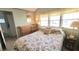 Cozy bedroom featuring a bed, dresser, bedside table, and windows at 3333 26Th E Ave # 1132, Bradenton, FL 34208