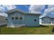 Exterior view of light blue home with white trim and a well-maintained lawn at 3333 26Th E Ave # 1132, Bradenton, FL 34208