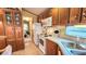 Bright kitchen featuring white appliances and ample wooden cabinetry for storage and efficiency at 3333 26Th E Ave # 1132, Bradenton, FL 34208