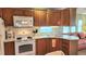 Well-lit kitchen with wood cabinets and appliances, seamlessly connected to a cozy living space at 3333 26Th E Ave # 1132, Bradenton, FL 34208
