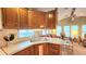 Bright kitchen with ample counter space, wood cabinetry, and a seamless transition to the living room at 3333 26Th E Ave # 1132, Bradenton, FL 34208