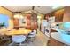 Cozy dining area with a wooden table, comfortable chairs, and built-in display cabinets at 3333 26Th E Ave # 1132, Bradenton, FL 34208