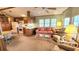 Inviting living room with bright windows and comfortable seating arrangement with connected kitchen at 3333 26Th E Ave # 1132, Bradenton, FL 34208