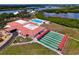 Overhead view of a community clubhouse with a pool, shuffleboard, and well-maintained landscaping at 4102 Lakewood Ave, Bradenton, FL 34208