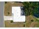 Aerial view of the home showcasing its layout, white roof, driveway, and proximity to the pond at 4102 Lakewood Ave, Bradenton, FL 34208