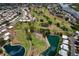 Aerial view featuring residences near a golf course, with lush landscaping and serene water features at 4102 Lakewood Ave, Bradenton, FL 34208