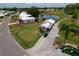 Aerial view showcasing a residence near golf course, pond and lush landscape at 4102 Lakewood Ave, Bradenton, FL 34208
