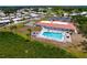 Aerial showing a community pool, a clubhouse, shuffleboard courts and residences at 4102 Lakewood Ave, Bradenton, FL 34208