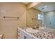 Neutral bathroom featuring patterned tile countertop and large mirror at 4102 Lakewood Ave, Bradenton, FL 34208