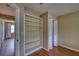 Spacious bedroom with wood-look floors, built-in shelving, and a bi-fold closet for ample storage space at 4102 Lakewood Ave, Bradenton, FL 34208