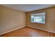 Bright bedroom with wood-look flooring, large window, and serene water views overlooking the lake at 4102 Lakewood Ave, Bradenton, FL 34208