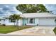 Charming single-story home featuring a white tile roof, attached garage, and well-maintained landscaping at 4102 Lakewood Ave, Bradenton, FL 34208