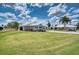 Charming single-story home with a well-manicured lawn, golf cart, and lush landscaping at 4102 Lakewood Ave, Bradenton, FL 34208