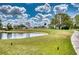 Picturesque view of the golf course, showing lush green fairways, serene lake, and manicured grounds at 4102 Lakewood Ave, Bradenton, FL 34208