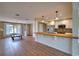 The kitchen overlooks the living room with a breakfast bar, modern lighting, and stainless steel appliances at 4102 Lakewood Ave, Bradenton, FL 34208