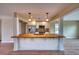 Bright, modern kitchen with a breakfast bar, stainless steel appliances, and pendant lighting at 4102 Lakewood Ave, Bradenton, FL 34208