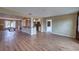Open-concept living space with wood flooring, a kitchen island, and abundant natural light at 4102 Lakewood Ave, Bradenton, FL 34208