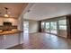 Spacious living room with wood floors, open to the kitchen and featuring sliding glass doors to the outside at 4102 Lakewood Ave, Bradenton, FL 34208