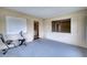 Enclosed patio area, featuring exercise equipment, with windows providing natural light and a view to the outside at 4102 Lakewood Ave, Bradenton, FL 34208