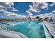 Tranquil pool area featuring sparkling water, plenty of lounge chairs, and clear blue skies at 4102 Lakewood Ave, Bradenton, FL 34208