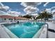 A refreshing swimming pool with lounge chairs and the building in the background at 4102 Lakewood Ave, Bradenton, FL 34208